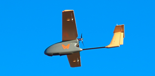 dron płatowiec z aparatem fotogrametrycznym na tle nieba